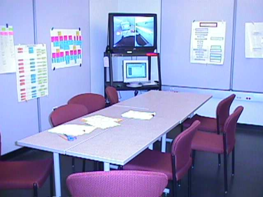 Photo of the war room: a table with a TV to observe the user