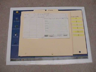 Photograph of a paper. Prototype is made form white paper, manila folders & yellow sticky paper. Small photograph gives overview, but not details. 